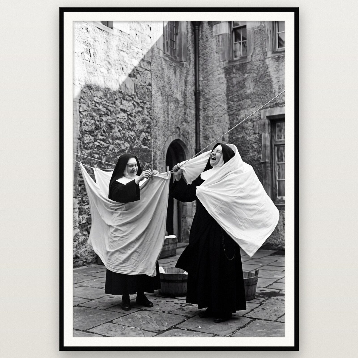 Nuns Hanging Out The Washing shown framed on a wall