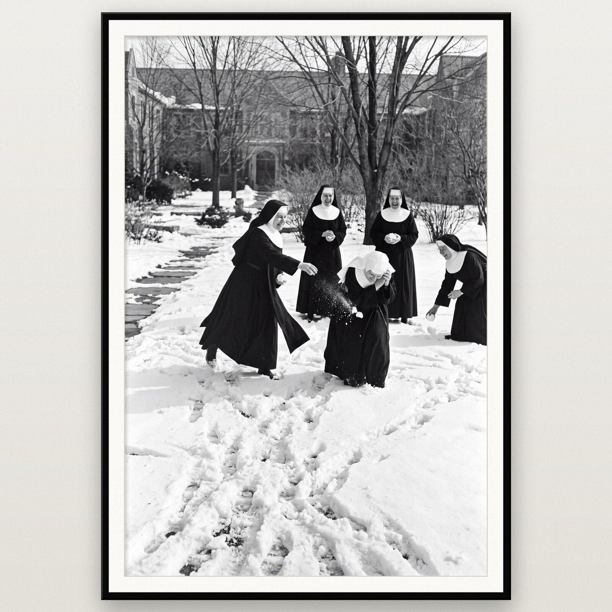 Nuns In The Snow shown framed on a wall
