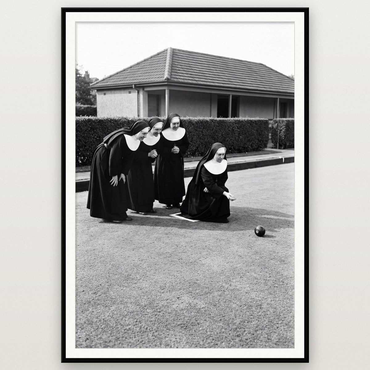 Nuns Playing Bowls shown framed on a wall