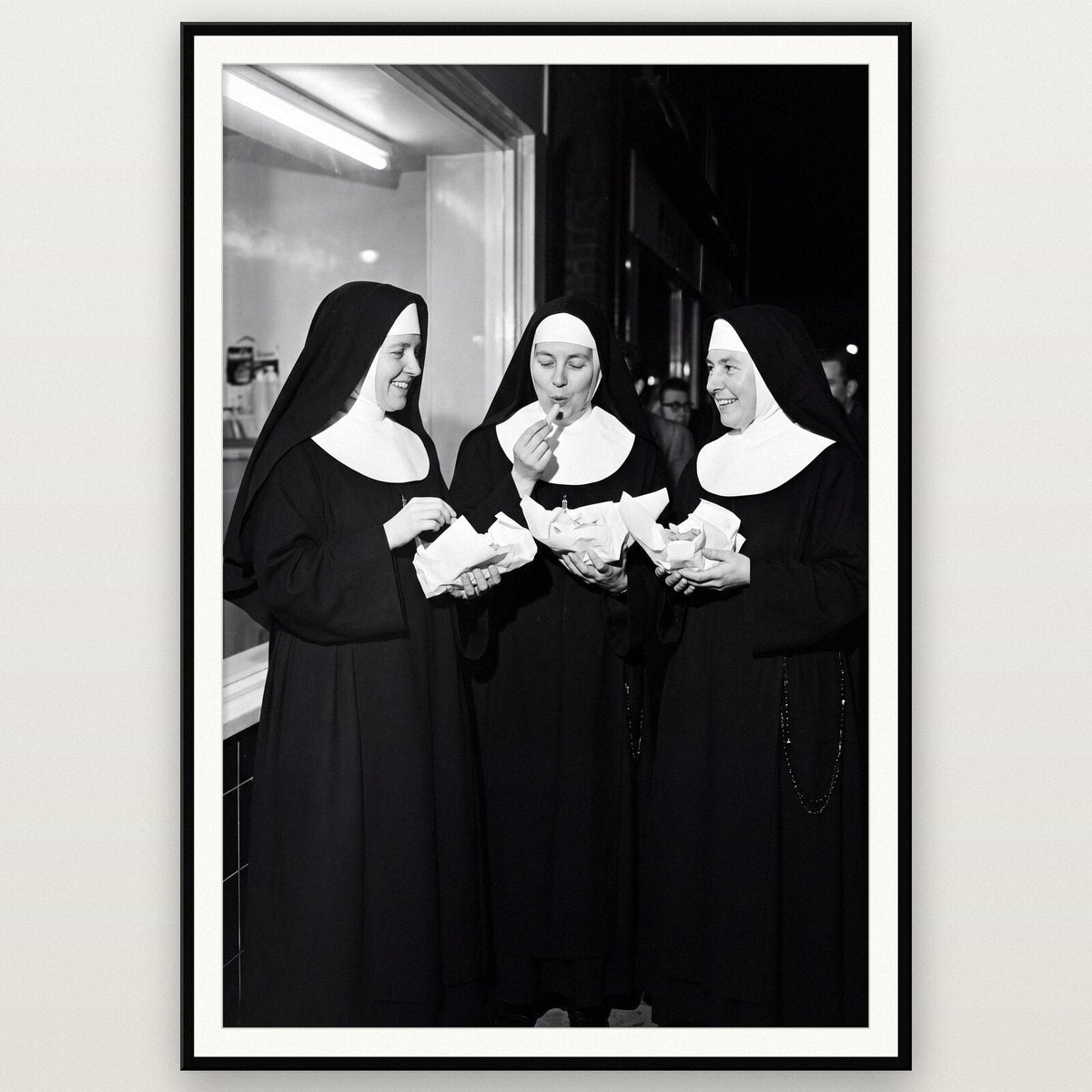 Nuns At The Chip Shop shown framed on a wall