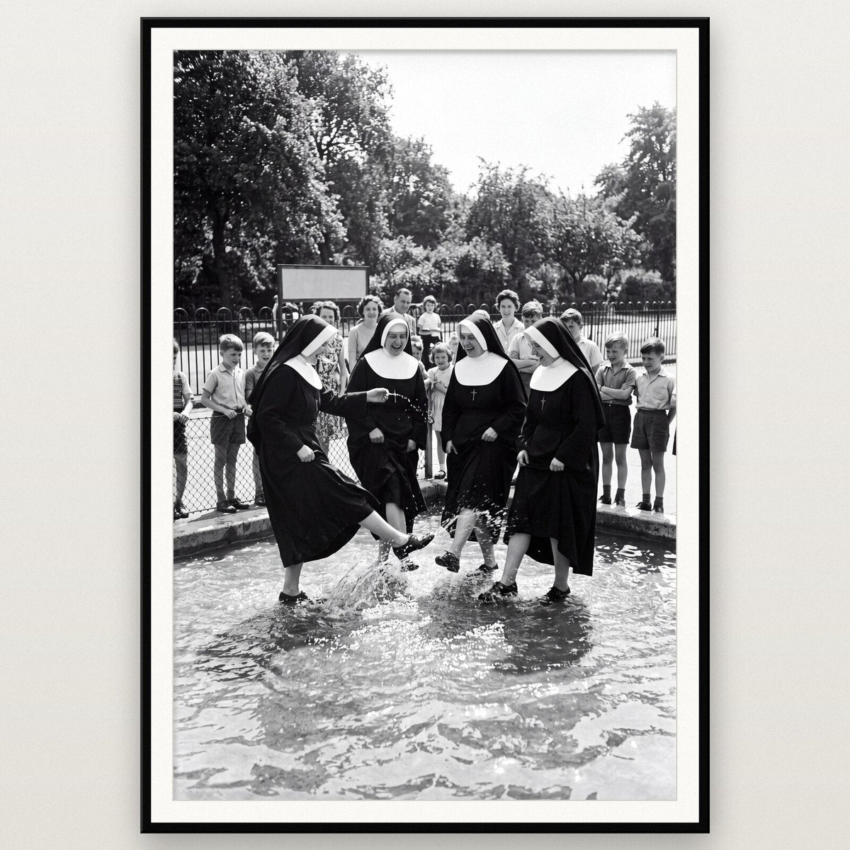 Nuns In The Paddling Pool shown framed on a wall